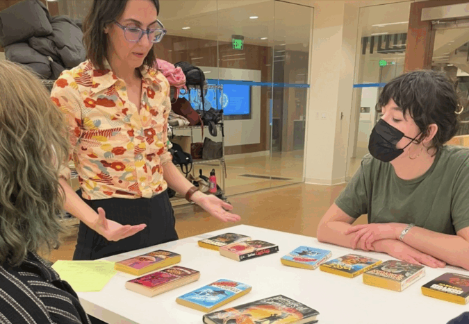 Jet Jacobs, head of public services, outreach and community engagement and interim assistant director of UCLA LSC discusses sci-fi pulp novels with students